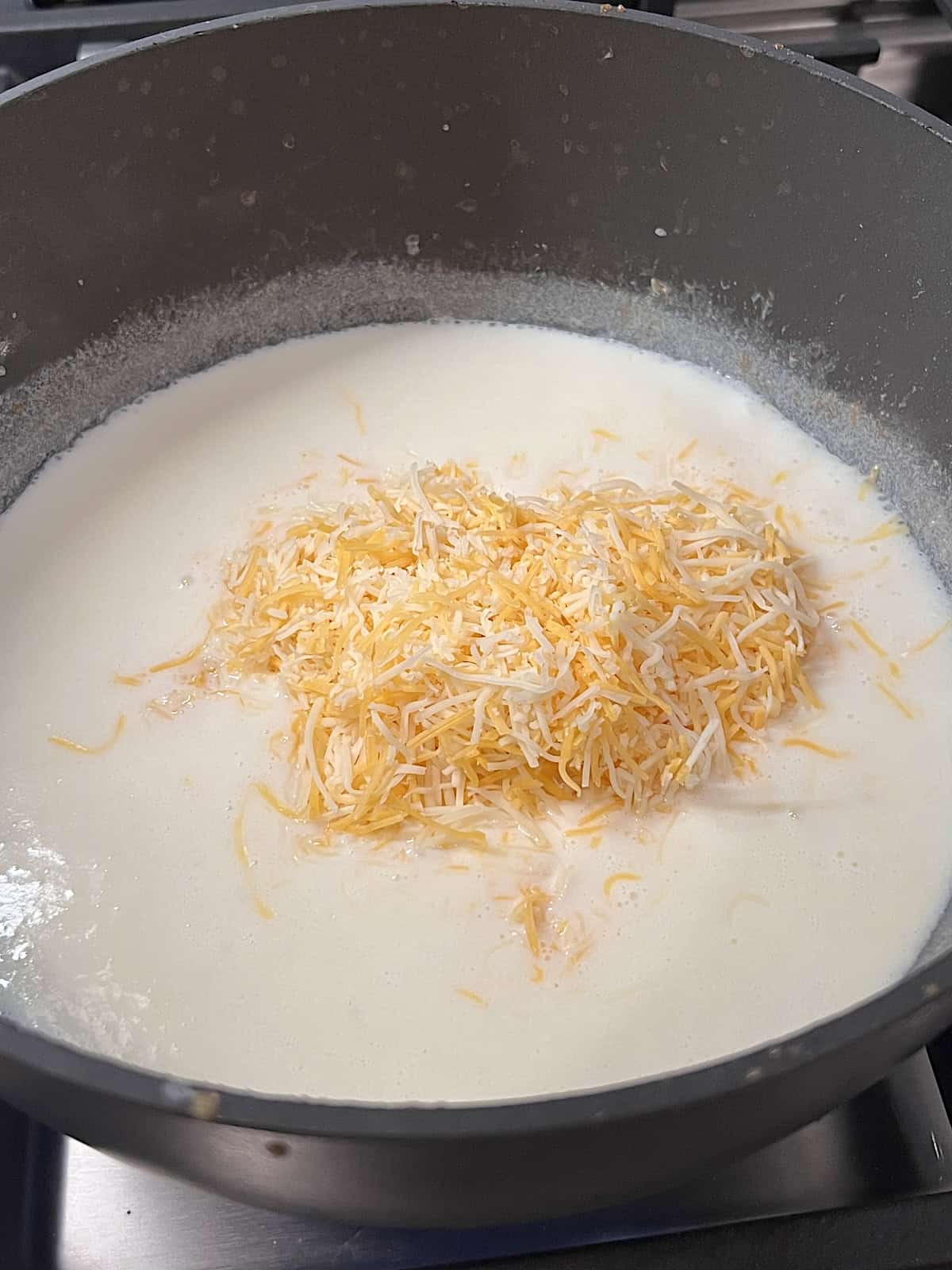 Chicken Broccoli Mac & Cheese Making the cheese sauce in a pot on the stove.