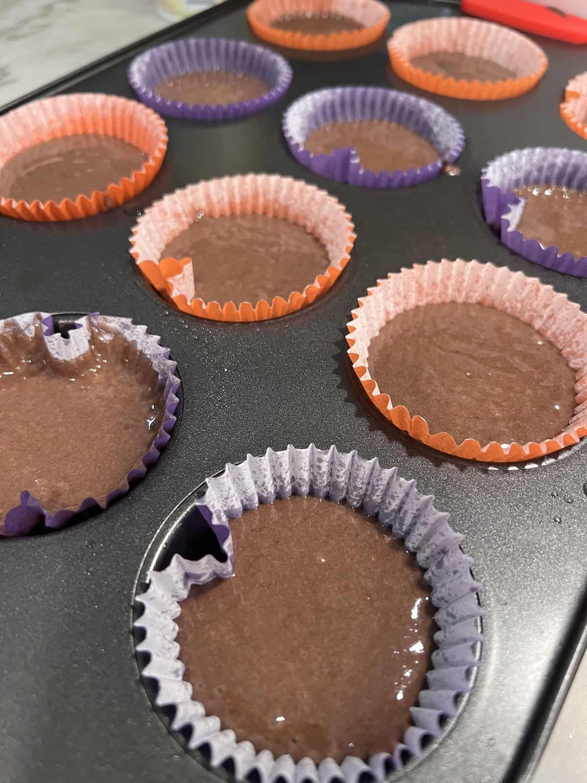 Halloween Cupcakes Batter in sprayed cupcake liners in the pan ready to bake.