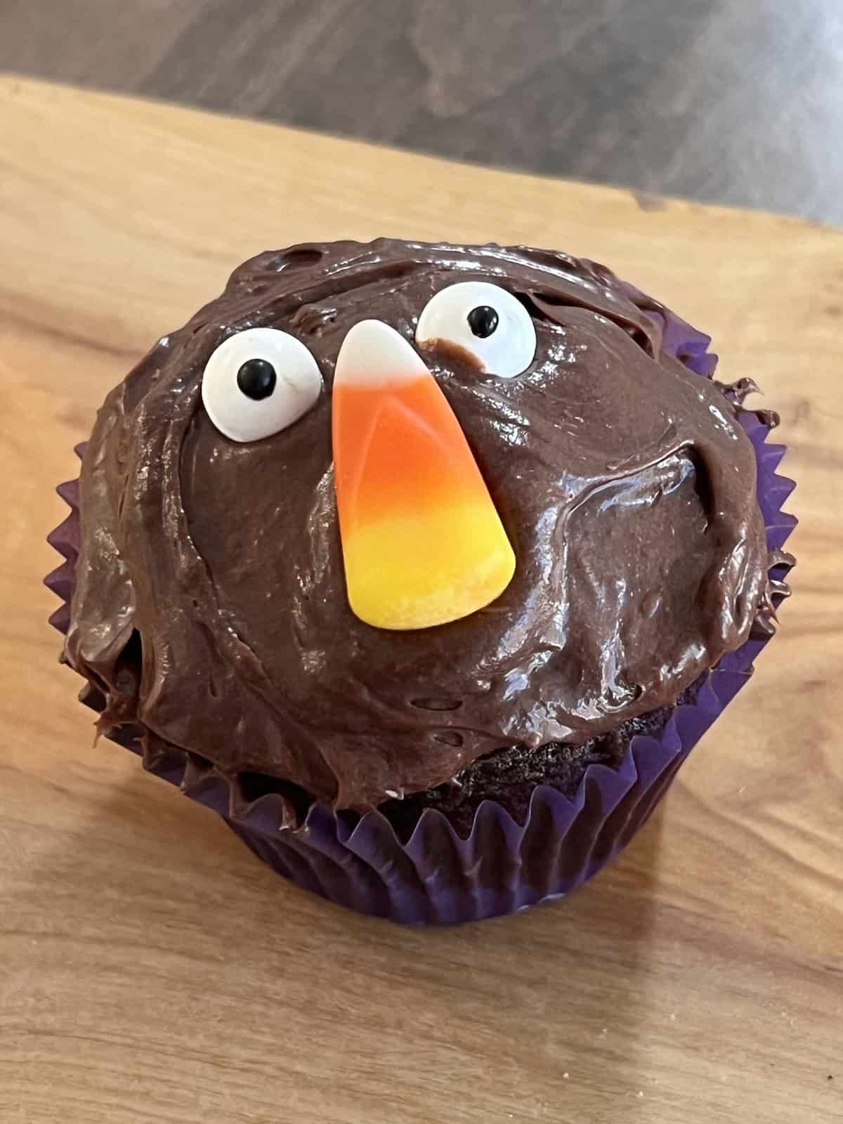 Halloween Cupcakes Decorated like a face with candy eys and candy corn nose.