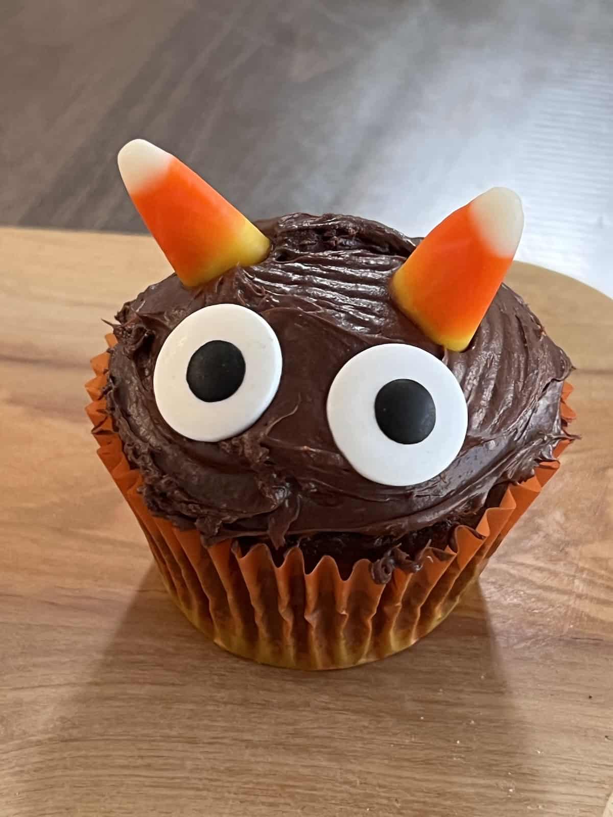Decorated like a monster with big candy eyes and candy corn horns.
